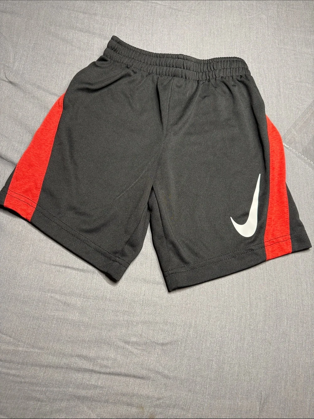 Nike Black Kids Shorts with Red Accent and White Swoosh